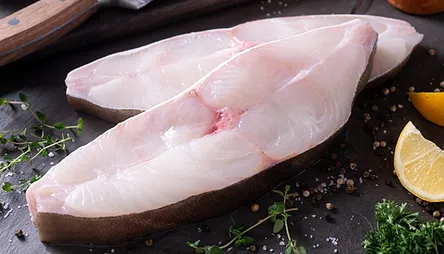 Delicious fresh halibut steaks on slate 