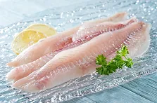 Fresh haddock fillets on glass plate wit